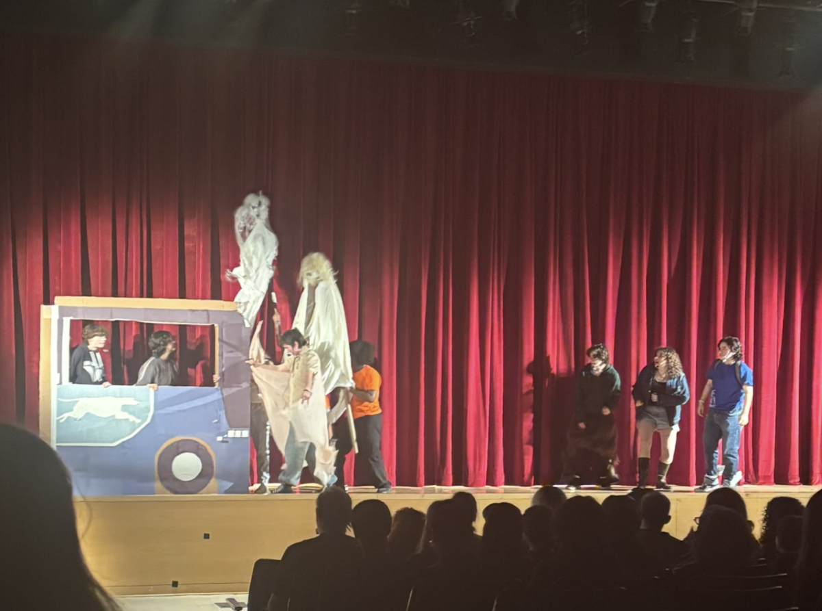 Two groups of actors face off across the stage, bringing the scene to life with vibrant costumes and intricate props.